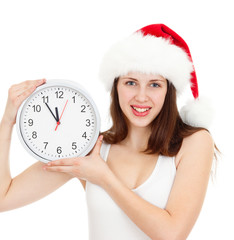 Cute girl in Christmas red santa hat with clock over a white bac