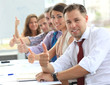 © opolja - Businessteam with thumbs up after a presentation in office