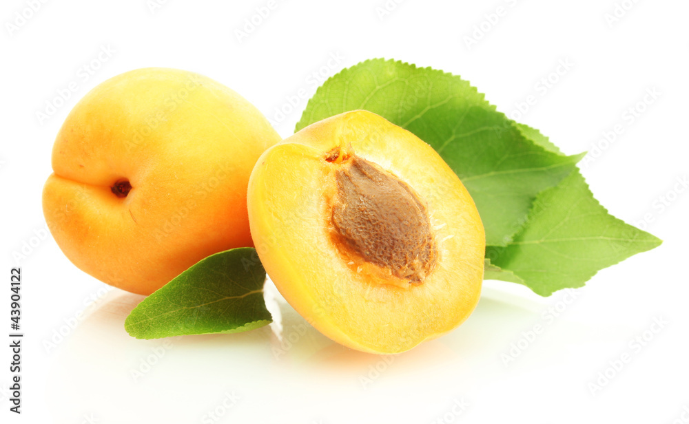 ripe sweet apricots with green leaves isolated on white