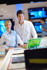 Wall Mural - Young couple in consumer electronics store