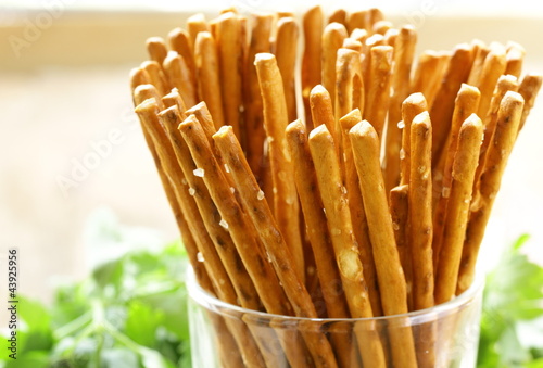 Cuadros en Lienzo salty pretzel snack bread sticks in a glass on the table
