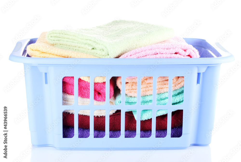 Plastic basket with bright towels isolated on white