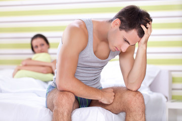 Unhappy couple in bedroom