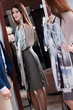 © Karramba Production - Woman admires the beauty of new dress at the mirror in the store