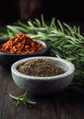 Sticker - Black pepper in bowl; chili flakes and rosemary in background