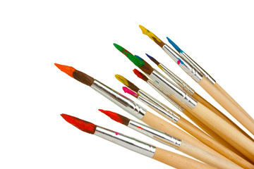 Paint brushes with gouache isolated on white