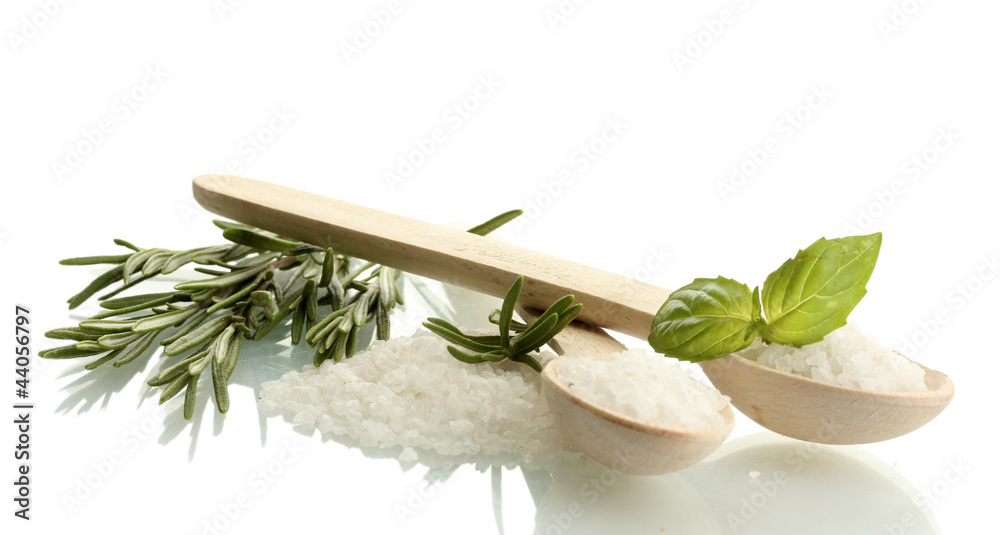 salt in spoons with fresh basil and rosemary isolated on white