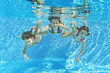 © Iuliia Sokolovska - Happy family underwater in swimming pool, fun on summer vacation