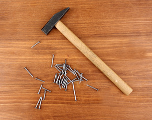 Poster - Hammer and metal nails on wooden background