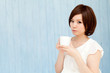 © one - Beautiful young business woman drinking tea