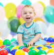© Andrey Kuzmin - Cute boy playing colorful balls