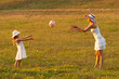 Mother and daughter throwing ball to each other