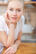 © listercz - Beautiful relaxed woman standing at the kitchen counter