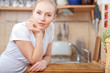 © listercz - Beautiful relaxed woman standing at the kitchen counter