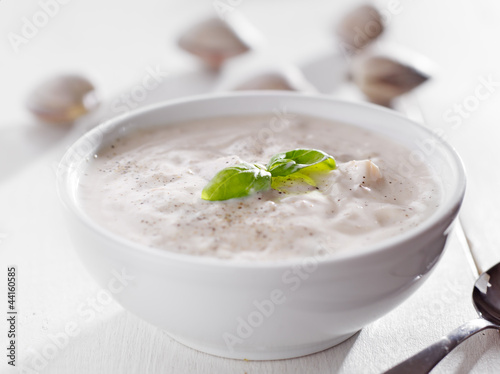 Fotografie, Obraz Bowl of new england clam chowder with basil garnish.