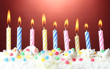 Poster - beautiful birthday candles  on red background