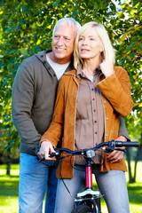 Poster - Happy senior couple cyclist.