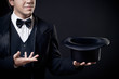 closeup of magician showing tricks with top hat isolated