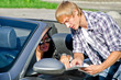 © M-Production - Male tourist asking female driver about direction