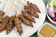Duck Satay served with peanut sauce, red onions and cucumber.