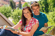 © CandyBox Images - Young happy couple on vacation with map