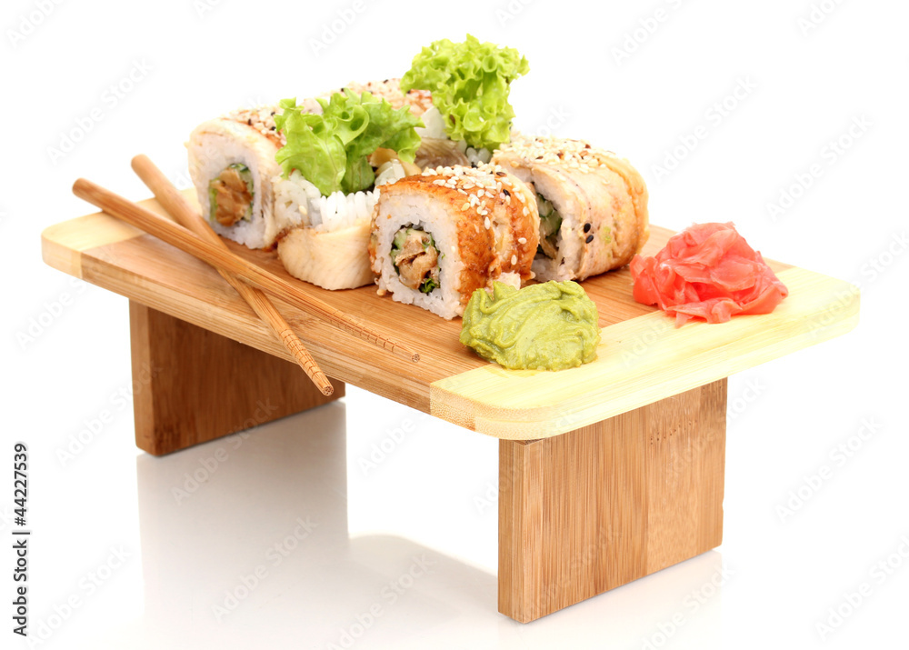 Tasty rolls served on wooden plate isolated on white