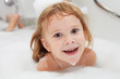 © altanaka - Cute four year old girl taking a relaxing bath with foam.