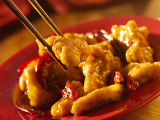 Wall Mural - Chinese food - Eating general tso's chicken with chopsticks.