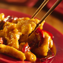 Wall Mural - Chinese food - Eating general tso's chicken with chopsticks.