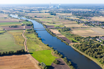 aerial view of power plant , river and harvest  fields