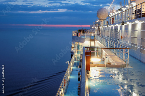 Deck of multidecked ship in evening light. Poster