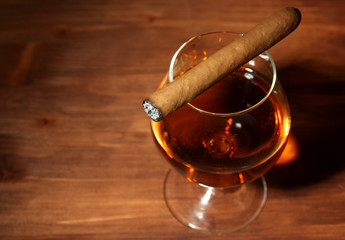 Poster - glass of brandy and cigar on wooden table