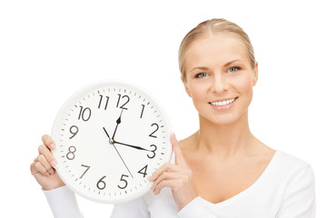 woman holding big clock