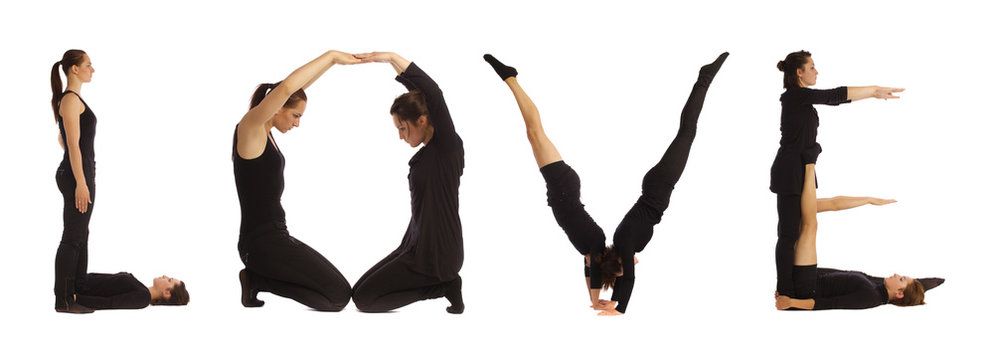 Black dressed people forming LOVE word over white 