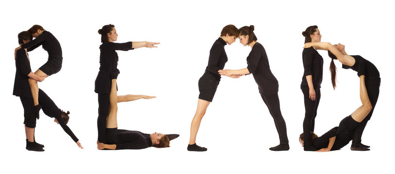 Black dressed people forming READ word over white 