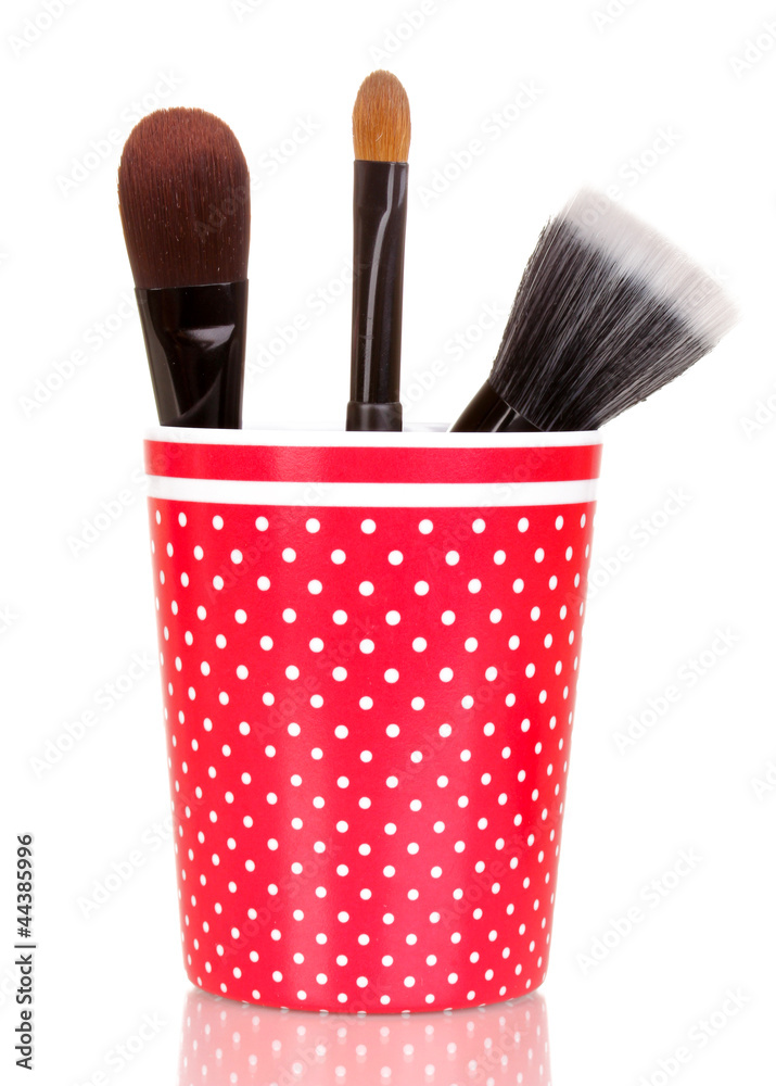 Cosmetic brushes in cup isolated on white