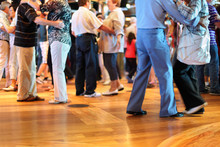 Many Happy Senior Couples In Love Dancing On Wooden Dance Floor.