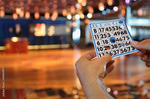 Hands hold bingo card with holes © Pavel Losevsky