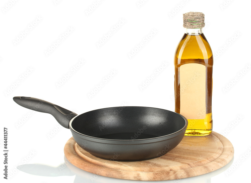 Pan with bottle of oil isolated on white