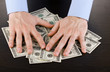 male hands hold dollars on a wooden table close-up