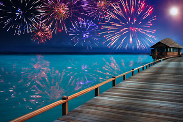 Wall Mural - Festive New Year's fireworks over the tropical island