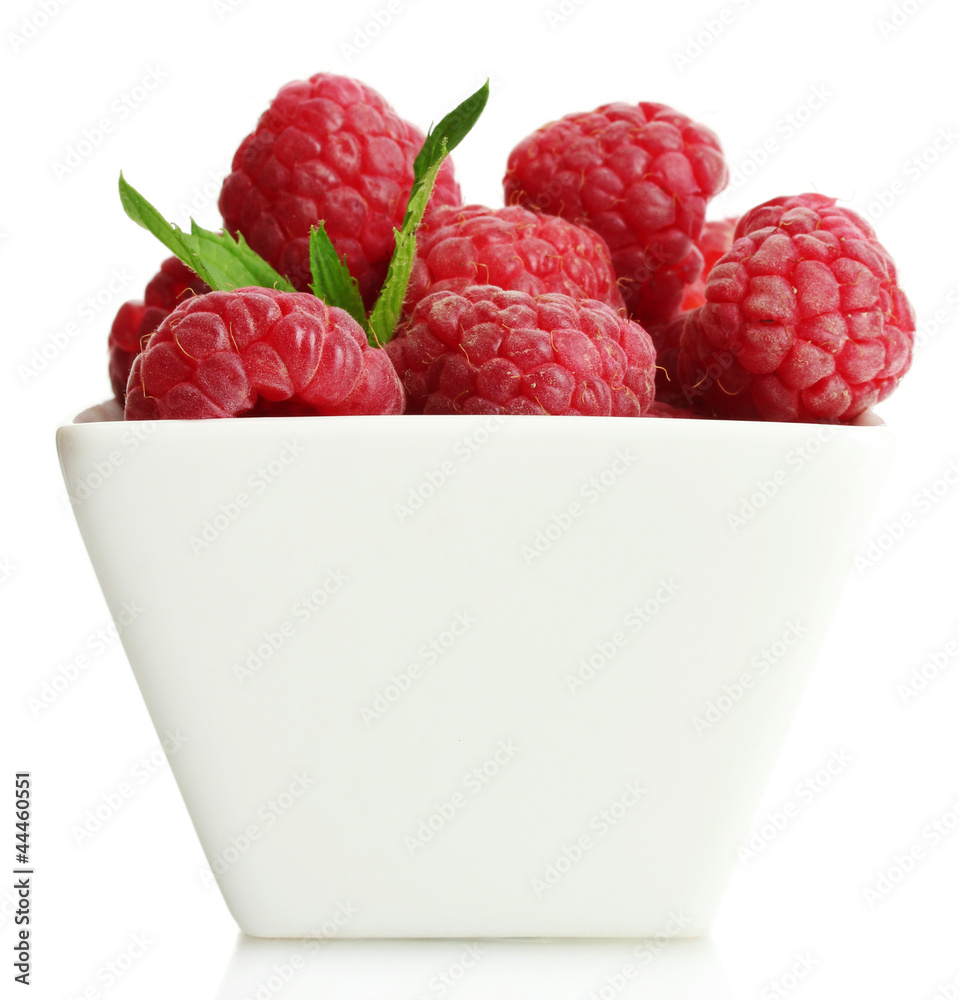 ripe raspberries with mint in bowl isolated on white