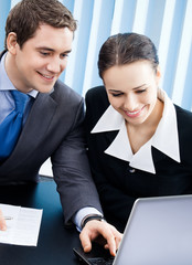 Businesspeople working with laptop at office