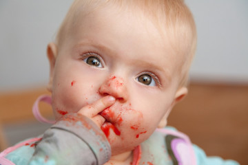 baby girl eating, dirty face