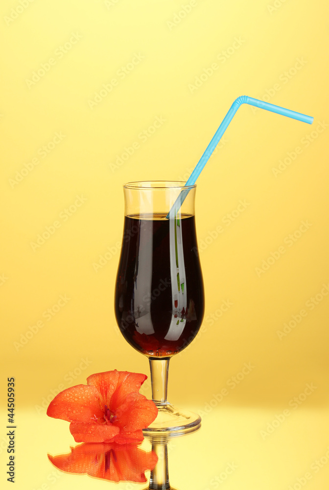 glass with cocktail and gladiolus bud