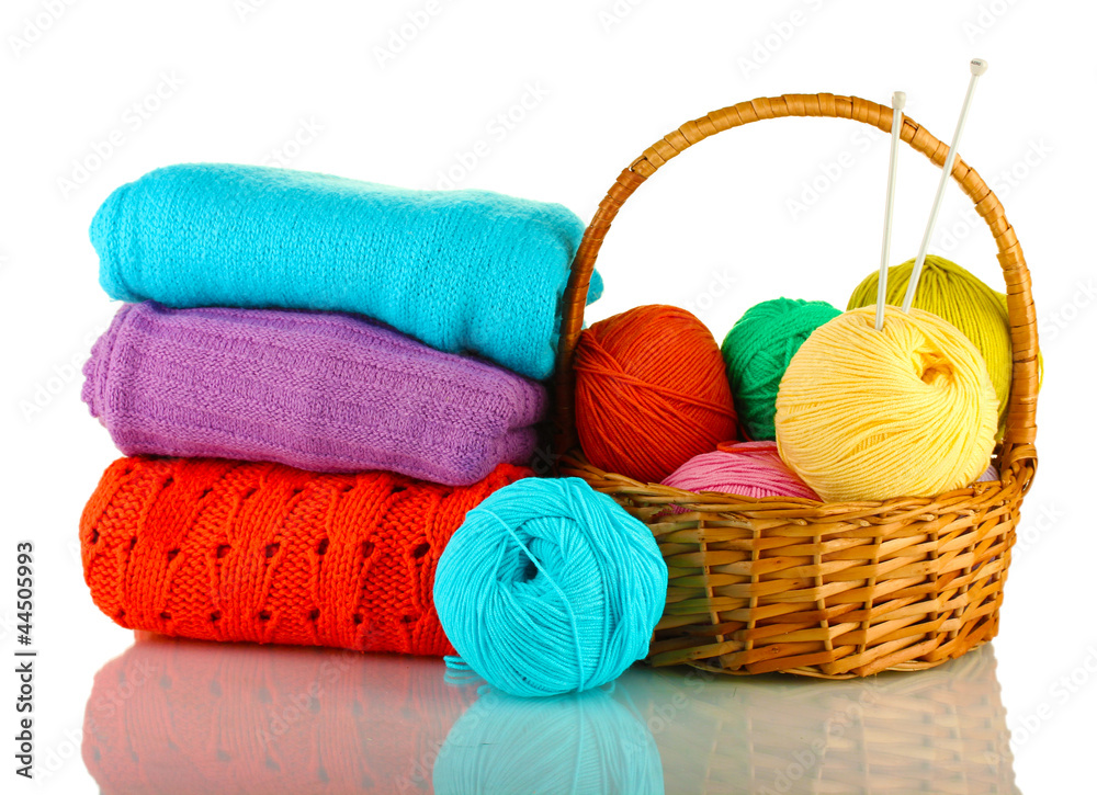 Sweaters and balls of wool isolated on white