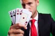 © Viorel Sima - young business man showing a four of a kind hand of aces