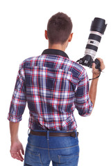 professional male photographer holding his camera