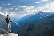 © petunyia - Young businessman using his laptop on the mountain top