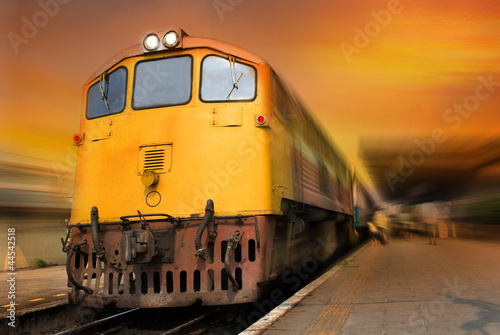Fototapeta na wymiar Train passing by in orange sunset